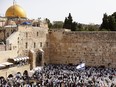 Jewish worshippers pray before the traditional priestly blessing prayer on the holiday of Passover, at the Western Wall in Jerusalem's Old City, on April 18, 2022.