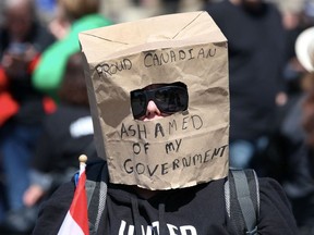 A supporter wears a paper bag at a rally on Parliament Hill during Rolling Thunder Convoy April 30, 2022 in Ottawa, Canada.