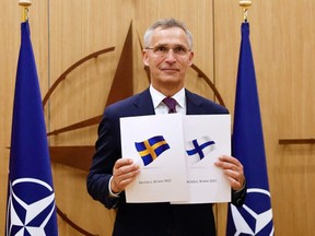 NATO Secretary-General Jens Stoltenberg poses during a ceremony to mark Sweden's and Finland's application for membership in Brussels, on May 18, 2022.