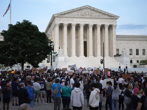 Pro-choice activists protest during a rally in front of the U.S. Supreme Court in response to the leaked draft decision to overturn Roe v. Wade, May 3, 2022 in Washington, DC.