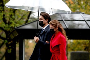 Justin Trudeau and spouse Sophie Gregoire Trudeau sport face masks while outdoors on the grounds of Rideau Hall on Oct. 26, 2021.