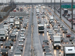 Cars sit in traffic on Highway 401 in Toronto.