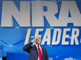 Donald Trump takes the stage to address the National Rifle Association's annual conference at the Lucas Oil Stadium in Indianapolis, April 26, 2019.