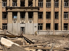 A Ukrainian soldier walks in front of a school that was bombed amid Russia's invasion in Ukraine, in Kostyantynivka, in the Donetsk region, Ukraine, May 8, 2022. REUTERS/Jorge Silva