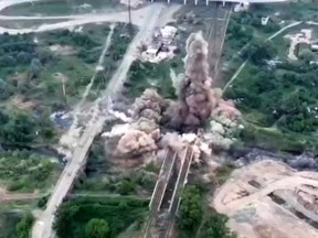 Ukraine forces blow up a bridge in Sievierodonetsk connecting the city and Lysychansk to Rubizhne, to stall Russia's progress, May 18, 2022.