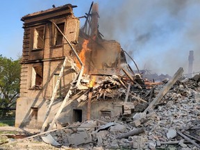 Debris is seen next to a partially collapsed building is seen, after a school building was hit as a result of shelling, in the village of Bilohorivka, Luhansk, Ukraine, May 8, 2022.