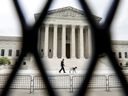 The U.S. Supreme Court is seen through a fence that was installed following protests over the leaked opinion suggesting the possibility of overturning Roe v. Wade, in Washington, D.C., on May 5.