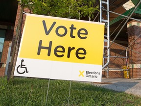 A voter leaves a polling station in the village of Limoges as Ontario prepares to bring in a new government.  Photo by Wayne Cuddington/ Postmedia