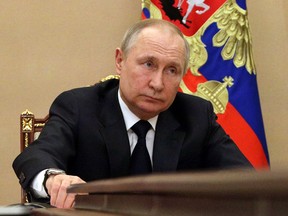 Russian President Vladimir Putin chairs a meeting with members of the Russian government via teleconference in Moscow on March 10, 2022.