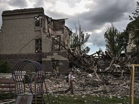 A man walks in front of a destroyed school in the city of Bakhmut, in the eastern Ukranian region of Donbas on May 28, 2022.