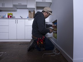 Master electrician Daniel Gadbois works on the electrical for a new housing construction site, in Kuujjuaq, Que., Wednesday, May 11, 2022.