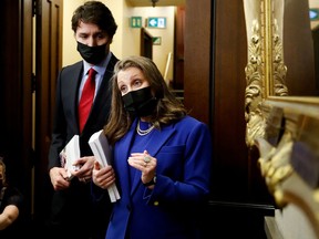 Finance Minister Chrystia Freeland, right, and Prime Minister Justin Trudeau speak to the media before delivering the 2022-23 budget, on Parliament Hill in Ottawa, on April 7.