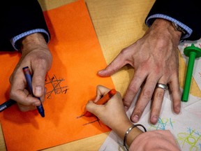 Prime Minister Justin Trudeau holds a crayon after he played, and lost, a game of tic-tac-toe against a child, following a new child care deal announcement with Ontario Premier Doug Ford (not pictured).