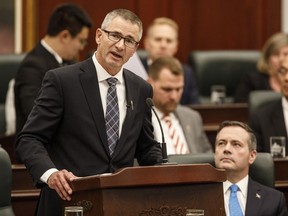 Alberta Finance Minister Travis Toews, left, delivers the provincial budget as Premier Jason Kenney looks on in Edmonton on Thursday, Oct. 24, 2019. Toews has officially entered the contest to replace Kenney as United Conservative Party leader and premier.