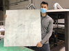 Corey Saban, founder and CEO of [RE] Waste, with a plastic sheet made from diverted plastic waste. PHOTO BY [RE] WASTE INSTAGRAM