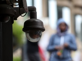 A video surveillance camera hangs by the side of a building. Canada's privacy commissioners are calling for laws limiting the use of the technology by police forces.