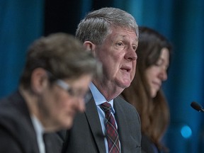 Michael MacDonald, chair, flanked by fellow commissioners Leanne Fitch, left, and Kim Stanton, delivers remarks at the Mass Casualty Commission inquiry into the mass murders in rural Nova Scotia on April 18/19, 2020, in Halifax on Monday, March 28, 2022.