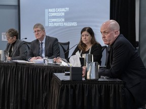 RCMP Cpl. Duane Ivany, a member of the force's emergency medical response team, fields questions as commissioners Leanne Fitch, Michael MacDonald, chair, and Kim Stanton, left to right, look on at the Mass Casualty Commission inquiry into the mass murders in rural Nova Scotia on April 18/19, 2020, in Dartmouth, N.S. on Thursday, May 5, 2022.