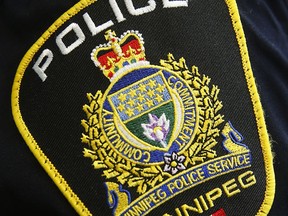 A Winnipeg Police Service shoulder badge is shown on an officer in Winnipeg on November 5, 2019. Police in Manitoba say they are investigating the death of a woman after they responded to a call for an assault.