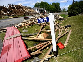 The remains of the roof of a hardware store that lifted off and crashed into neighbouring houses during a major storm is seen spread across residences in the community of Hammond in Clarence-Rockland, Ont., Monday, May 23, 2022.