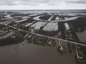 St Mary's Road, which runs between Winnipeg and St Adolphe, Man., is closed due to Red River flooding south of Winnipeg, Sunday, May 15, 2022.&ampnbsp;Dozens of experts advising the government on adapting to climate change say Canada's new adaptation strategy must move faster.