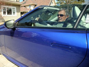 John Taylor sits in the vehicle with the tinted windows that earned him a $172 ticket from a Sûreté du Québec officer. He's planning to fight the ticket in court.