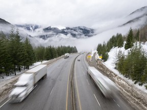 Vehicles are seen as they drive along the Coquihalla Highway Wednesday, Jan. 19, 2022. Highways through southern British Columbia's mountain passes looked more like mid-winter than mid-May early Friday as Environment Canada advised another five more centimetres of snow was expected before the latest unseasonable weather eased.
