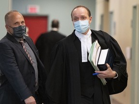 Quebec Crown prosecutor François Godin, right, walks to a courtroom, Thursday, Nov. 5, 2020, in Quebec City. The jury considering the fate of the accused in Quebec City's Halloween 2020 sword attack that left two people dead and five others injured is deliberating for a third day.