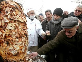 Turkish people wait in a queue for a chicken doner kebab prepared by Ankara Chicken Meat Distributers Platform in Ankara.