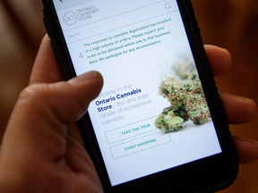 A Ontario Cannabis Store website pictured on a mobile phone Ottawa on Thursday, Oct. 18, 2018. THE CANADIAN PRESS/Sean Kilpatrick