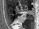 Königin Elizabeth II. schenkt der Menge aus ihrer Kutsche ein breites Lächeln, als sie nach ihrer Krönung die Westminster Abbey in London verlässt.