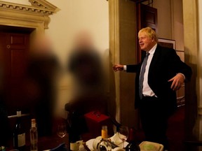 Prime Minister Boris Johnson is seen holding a drink at a gathering in 10 Downing Street on the departure of a special adviser, in a photo taken on November 13, 2020 and released on May 25, 2022.