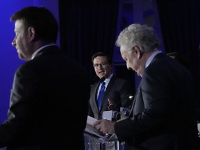 Candidates Roman Baber, left, Pierre Poilievre and Jean Charest, right, take part in the French language Conservative Leadership debate Wednesday, May 25, 2022 in Laval, Que..THE CANADIAN PRESS/Ryan Remiorz