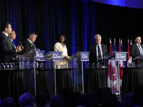 Conservative leadership hopefuls Pierre Poilievre, left to right, Patrick Brown, Scott Aitchison, Leslyn Lewis, Jean Charest and Roman Baber take part in the Conservative Party of Canada French-language leadership debate in Laval, Quebec on Wednesday, May 25, 2022.