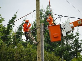 Hydro crews work to restore power in Clarence-Rockland, Ont., where a state of emergency is in place on Thursday, May 26, 2022.&ampnbsp;One week after severe thunderstorms swept through Ontario and Quebec, just over 60,000 homes in the two provinces remain without power today.&ampnbsp;THE CANADIAN PRESS/Sean Kilpatrick