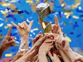 United States celebrate winning the women's world cup with the trophy.