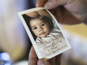 Alex Chen holds a photo of his daughter Ailah, who he and his wife Kristin lost to sudden infant death syndrome in June 2018.