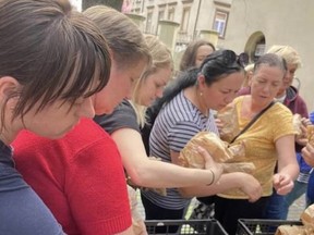 Sandwiches are distributed to Ukrainian refugees outside the Jewish Community Centre in Krakow, Poland, on May 4, 2022. Photo credit: Avi Benlolo