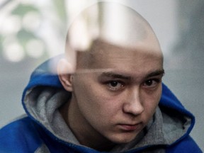 Russian soldier Vadim Shishimarin, 21, suspected of violations of the laws and norms of war, sits inside a defendants' cage during a court hearing, amid Russia's invasion of Ukraine, in Kyiv, May 13