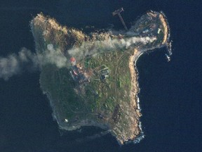 Satellite view shows smoke rising over Snake Island, Ukraine amid Russia's attack on the country, May 8, 2022 in this handout image.