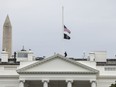 A White House staffer lowers the American flag to half-staff on May 24, 2022, in Washington, D.C, following the elementary school shooting in Texas.