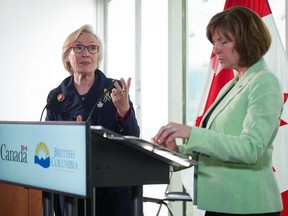 Federal Minister of Mental Health and Addictions and Associate Minister of Health Carolyn Bennett, back left, speaks as B.C. Minister of Mental Health and Addictions Sheila Malcolmson listens during a news conference after British Columbia was granted an exemption to decriminalize possession of some illegal drugs for personal use, in Vancouver, on Tuesday, May 31, 2022.