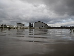 A barn on high ground is seen with receded floodwaters still surrounding it on a farm in Abbotsford, B.C., on Tuesday, November 23, 2021.
