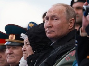 Russian President Vladimir Putin watches a military parade on Victory Day, which marks the 77th anniversary of the victory over Nazi Germany in World War Two.
