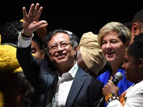 Newly elected Colombian President Gustavo Petro (C) celebrates next to his wife Veronica Alcocer and his running mate Francia Marquez at the Movistar Arena in Bogota, on June 19, 2022 after winning the presidential runoff election on June 19, 2022.