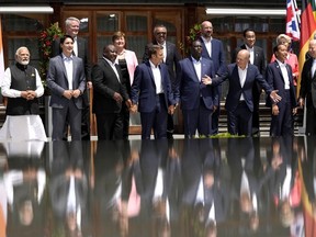 German Chancellor Olaf Scholz, center, right, gestures during a group photo of G7 leaders and Outreach guests at Castle Elmau in Kruen, near Garmisch-Partenkirchen, Germany, on Monday, June 27, 2022. The Group of Seven leading economic powers are meeting in Germany for their annual gathering Sunday through Tuesday.
