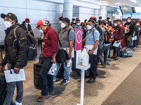 Frustrated travellers line up at Montréal-Pierre Elliott Trudeau International Airport on June 29, amid worker shortages and slowdowns.