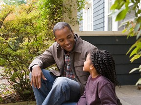 Father and daughter outside house