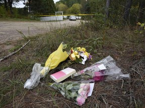 Flowers and a bible are left in a small memorial outside a home in Wilno, Ont. where the body of Anastasia Kuzyk was found on Tuesday, on Friday, Sept. 25, 2015.&ampnbsp;An inquest examining the deaths of three women killed by their former partner is hearing from an educator about how bystanders can respond to intimate partner violence. THE&ampnbsp;CANADIAN PRESS/Justin Tang