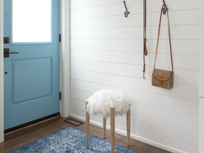 With a door painted Blue Daisy by Benjamin Moore, the entrance to the Wards' apartment is cheerful and welcoming.